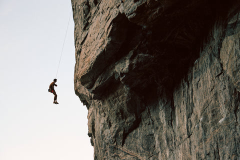 image of climber hanging from a rope