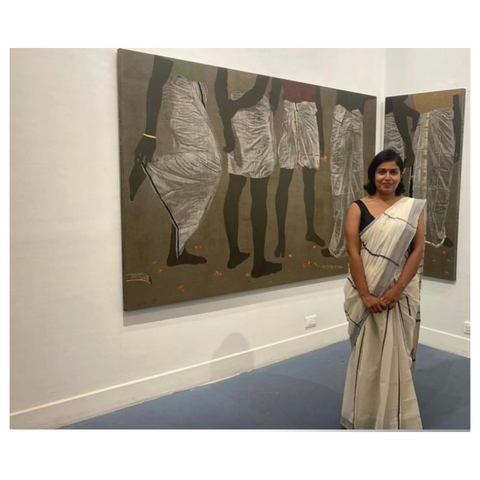 artist devi seetharam next to her work Brothers, Fathers and Uncles, wearing Ela India