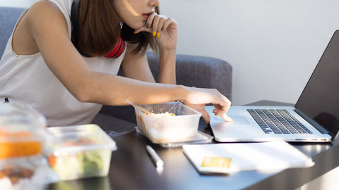 young-woman-working-while-having-unfinished-food-concepstory-blog-skipping-your-meals-segment