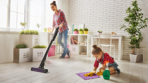 lady-cleaning-the-living-room-using-a-sharkninja-evo-power-aed-cordless-vacuumwith-her-daughter-helping-her-out-concepstory-concepstore-blog