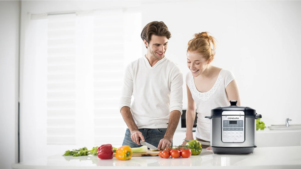 a-man-and-a-lady-chopping-vegetables-together-in-the-kitchen-counter-with-condura-multicooker