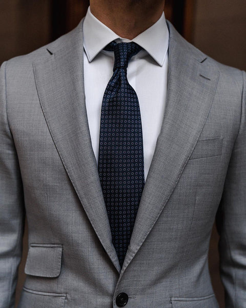 Light grey suit navy tie