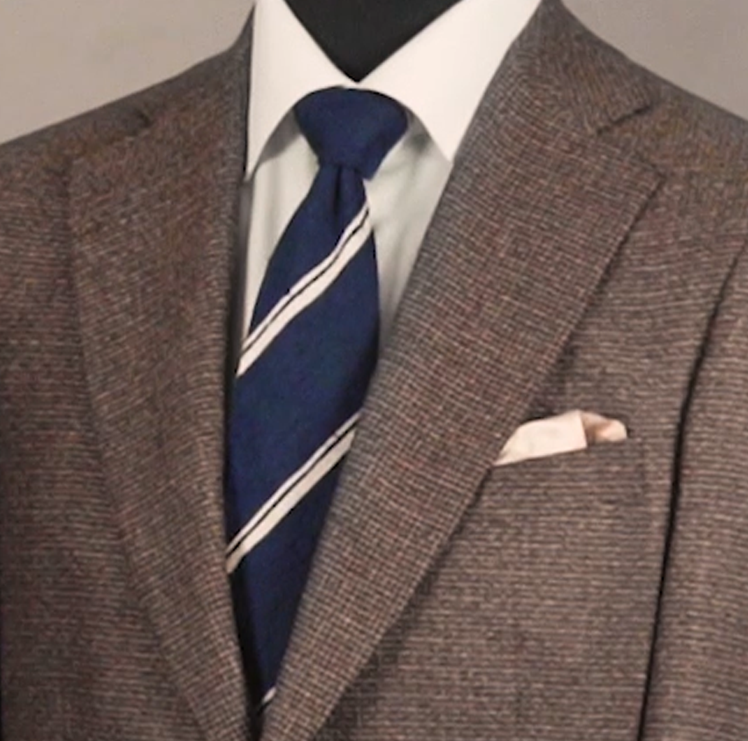 NAVY TIE AND LIGHT TONED POCKET SQUARE WITH BROWN JACKET