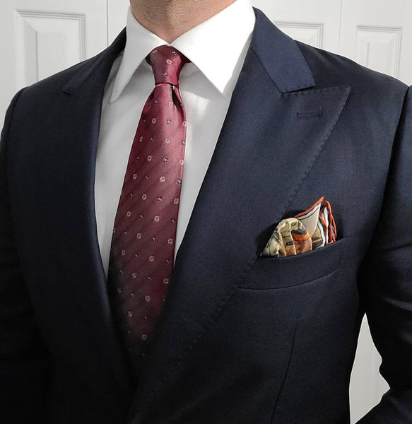 Navy suit burgundy tie pocket square
