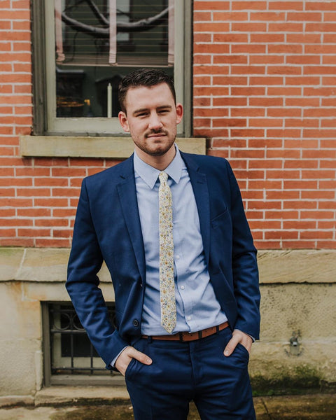 Rust tie with a light blue suit with chalk stripes