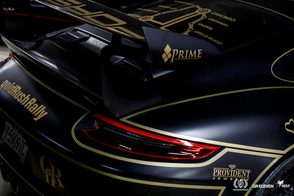View of the rear of a Porsche with goldRush Rally logo
