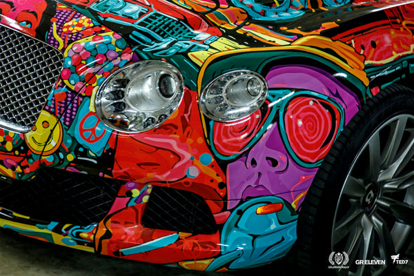 Close up of the headlights of a car with colorful vinyl wrap