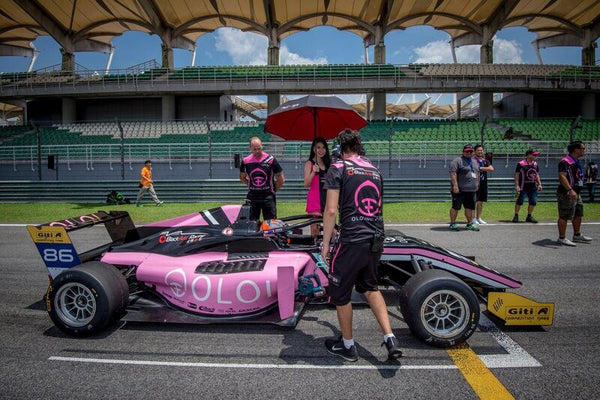 BlackArts Racing crew tend to the pink Oloi F3 car on the starting grid