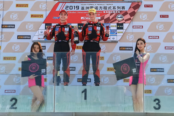 BlackArts Racing drivers pose on the winners' podium