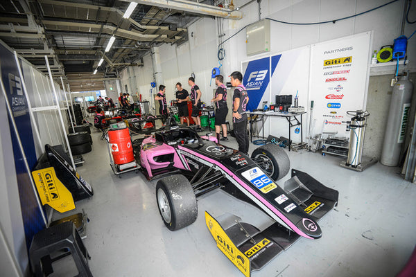 The pink Oloi F3 car in the BlackArts Racing Garage