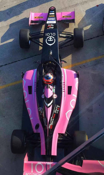 Arial view of the pink Oloi F3 car with driver on the starting grid