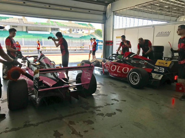 BlackArts Racing team powered by Oloi works on the F3 cars in the garage.