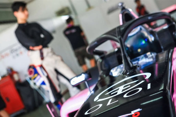 Closeup of pink Oloi F3 car with driver blurred in background