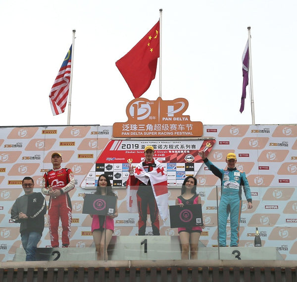 First, second, and third place finishers on the winner's podium