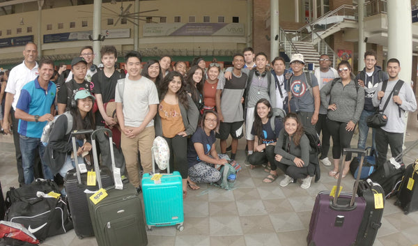 World Without Walls students gather for a group photo with their luggage at the airport