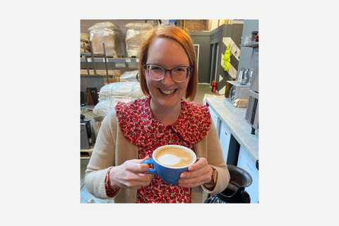 Sinead Communications Manager at 200 Degrees smiling with coffee