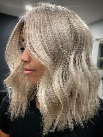 Lady with mid-length platinum blonde hair color