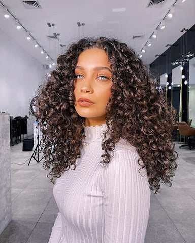 beautiful mixed race girl with salon soft curly hairstyle look
