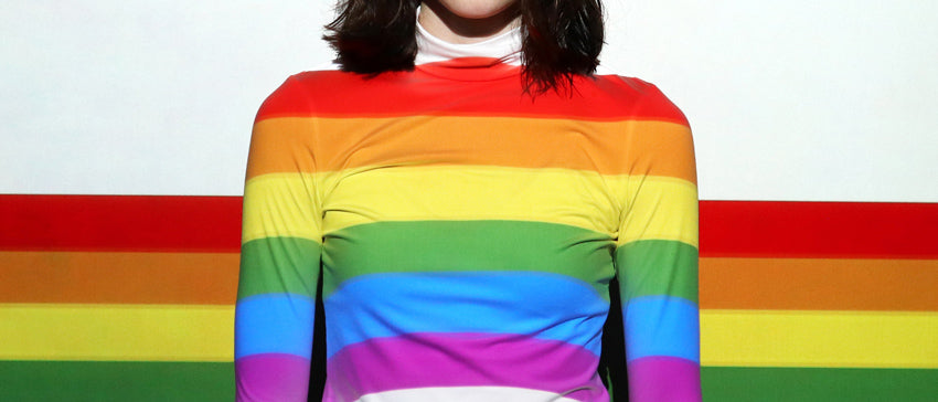 A person wearing a rainbow shirt