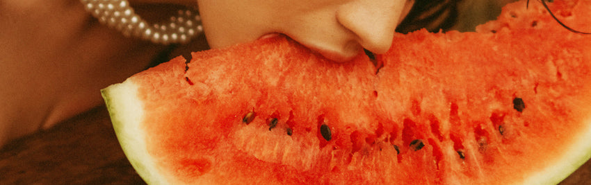 a person eating a piece of watermelon