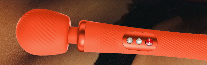 Orange Vim Vibrating Wand by Fun Factory on a woman's body background