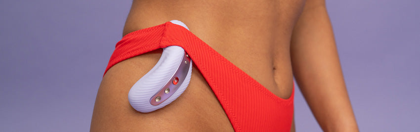 laya iii vibrator tucked into the side of a person's red underwear