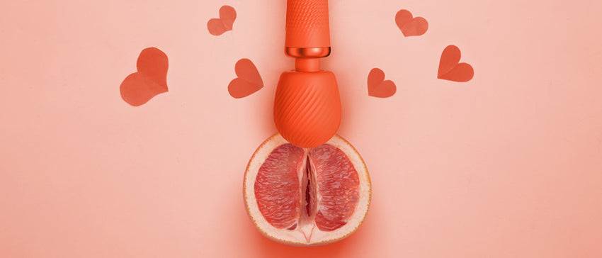 Sunrise Orange VIM Vibrating wand on a grapefruit