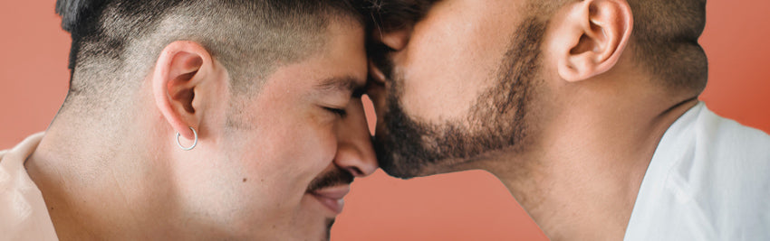 Man kissing a man on the forehead