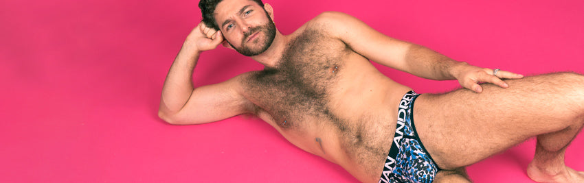 Zachary Zane posing on a pink floor in a his underwear