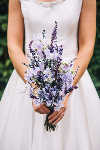 woman holding purple bouquet