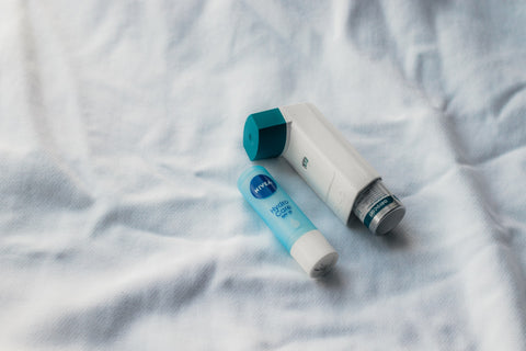 asthma inhaler on white sheet