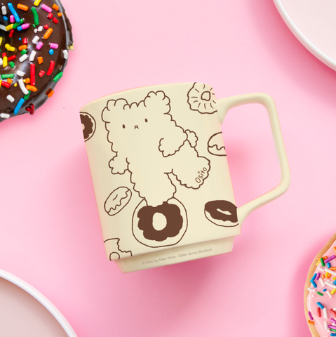 Osito cute teddy bear on a mug with donuts