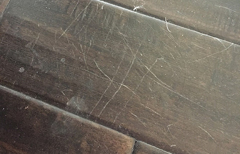 Dark hardwood floor with scratches