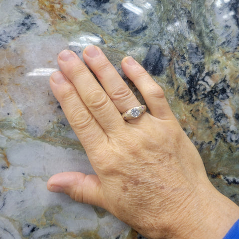 judy modeling her new heirloom diamond redesign ring in 14k and pink sapphires with granite as the background hkm jewelry