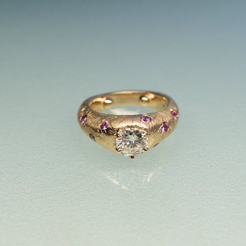 front of diamond and pink sapphire flush set textured ring 14k gold