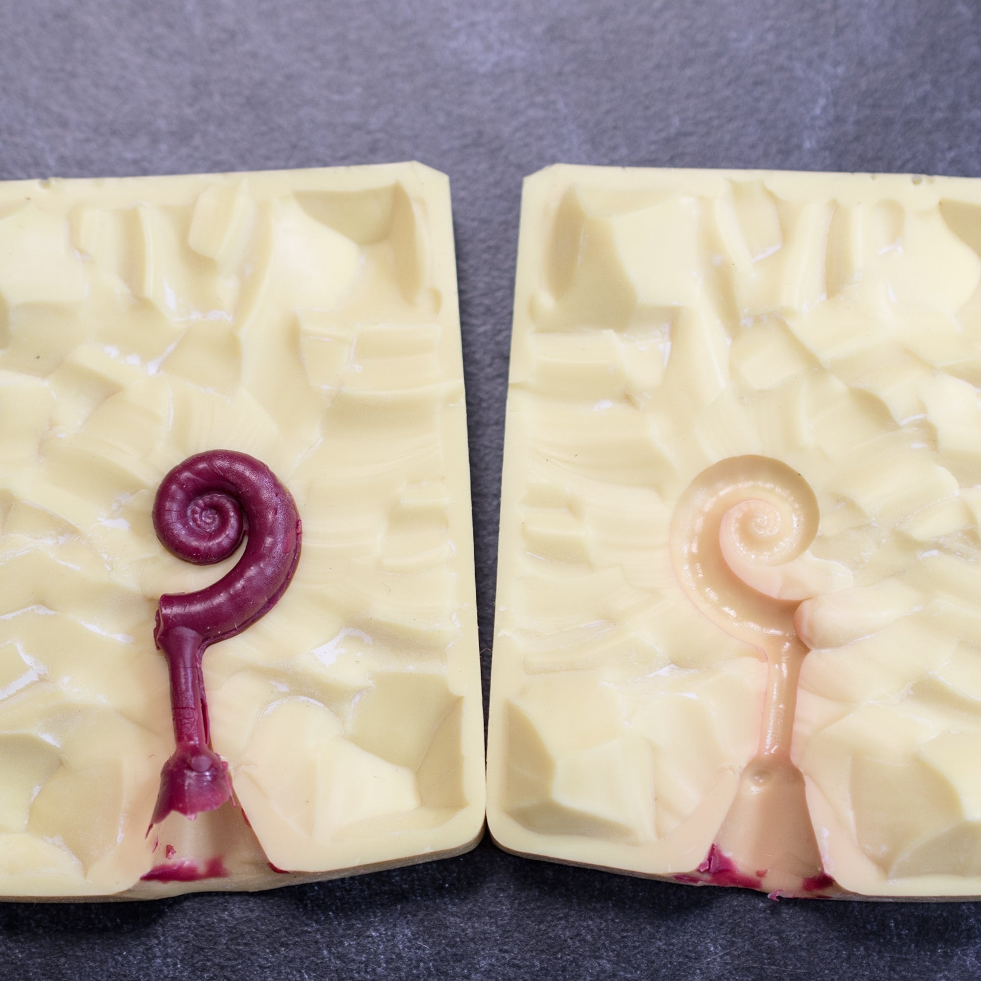 yellow silicone mold of rams horn squid shell for jewelry making showing wax cast