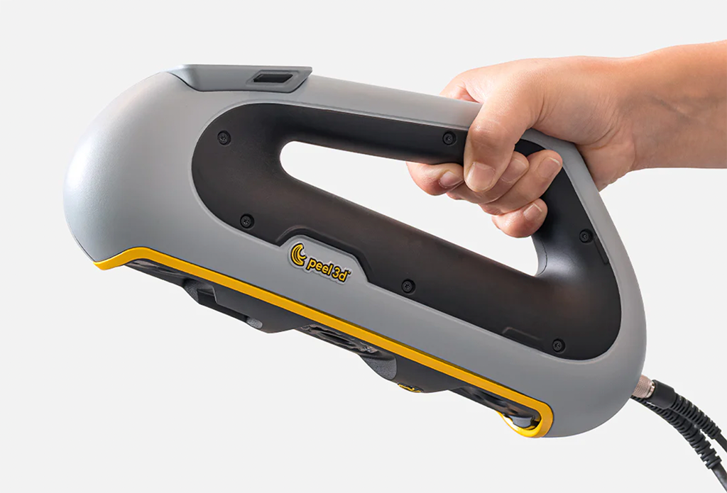 a hand holding a 3d scanner