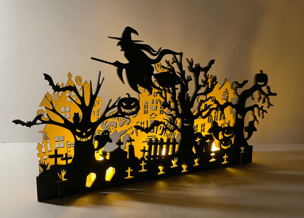 Laser Cut Halloween Decorations with a witch and scary graveyard