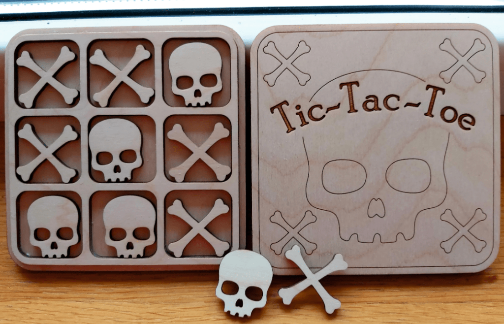 laser cut tic tac toe board with a skull on it