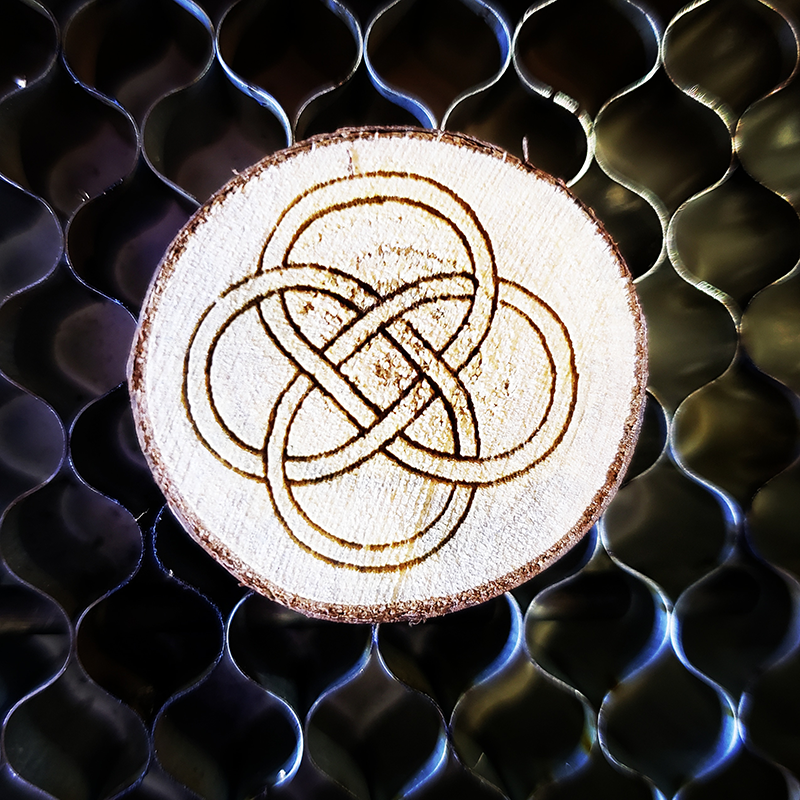 Applewood rounds engraved with a celtic design on a laser cutter