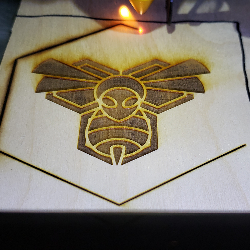 Murder Hornet design etched into plywood on a laser cutter
