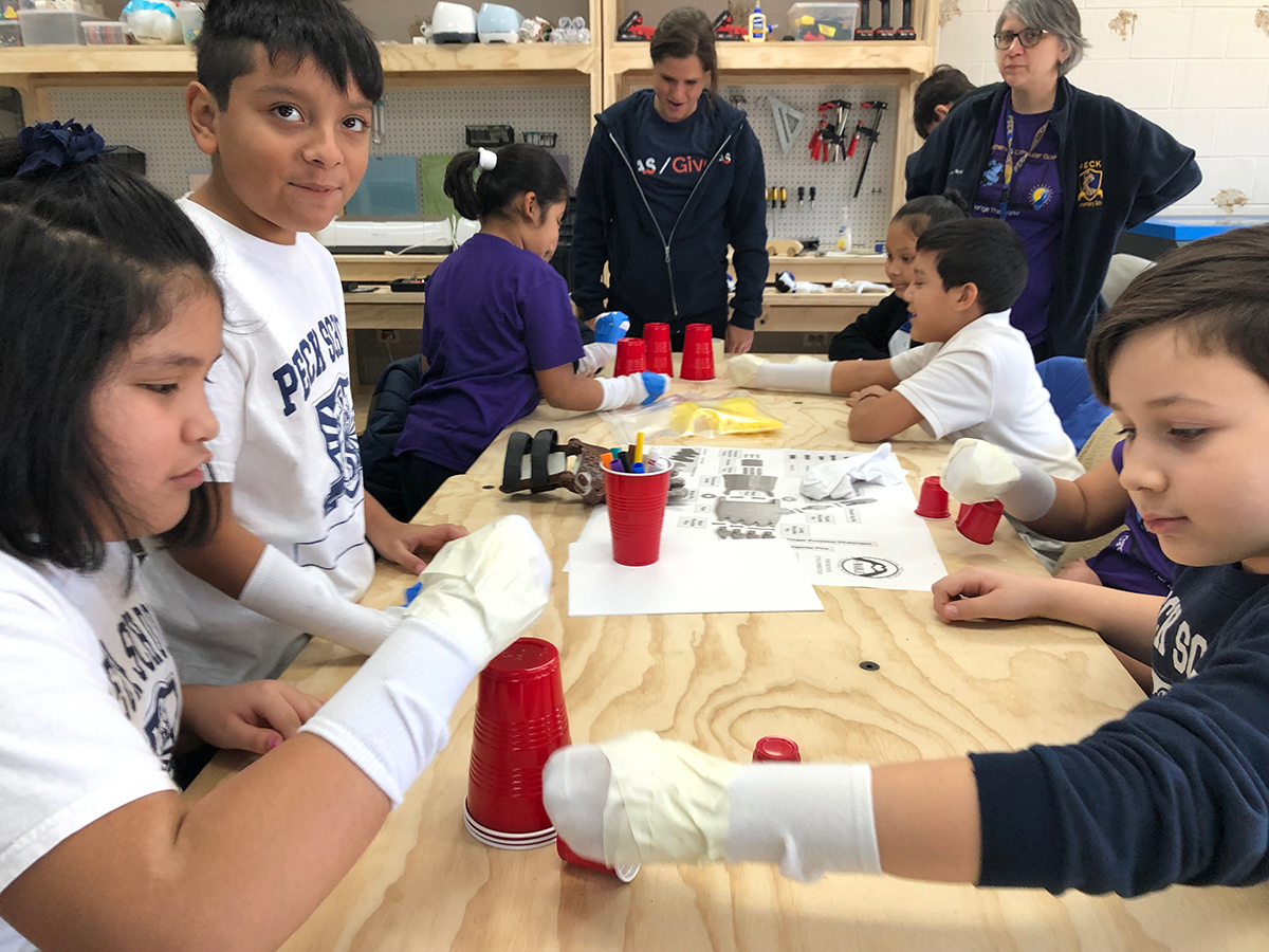 Peck Elementary students learn Empathy with socks on their hands to learn how it might be hard to have been born with one hand and have to do daily tasks.