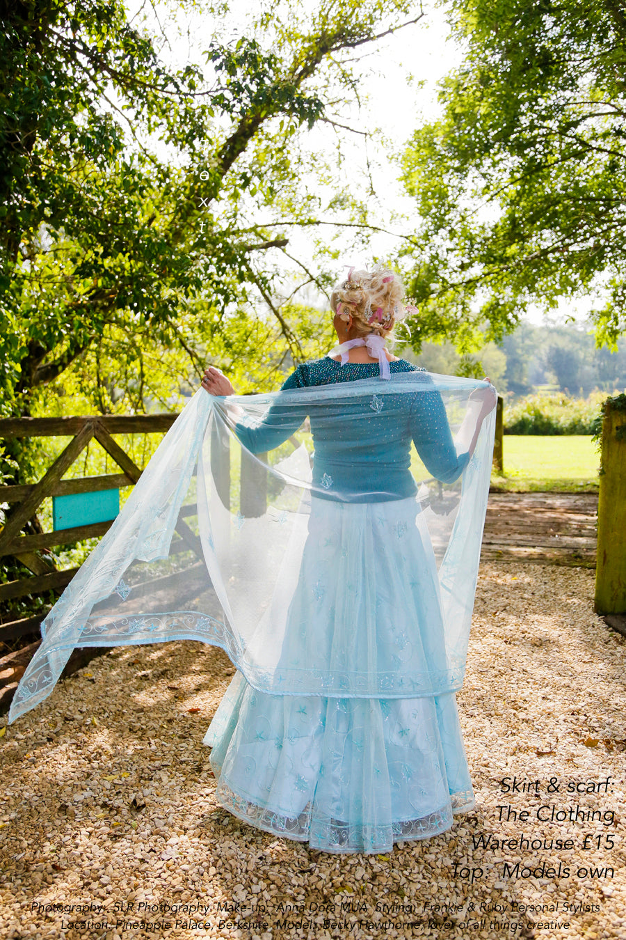 A model in a floaty blue dress wearing secondhand clothes