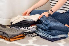 A woman organising her wardrobe