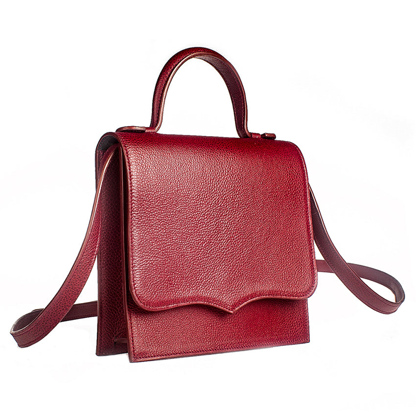 Angled view of red leather handbag