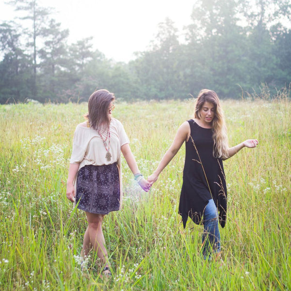 Founders anna and brittany in a grassy field