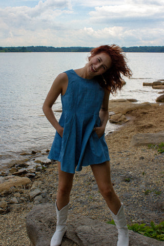 Aspen is wearing a denim romper near the lake for the 4th of july