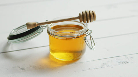 Jar of honey with spindle