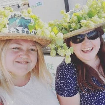 Ladies wearing hats decorated with hops