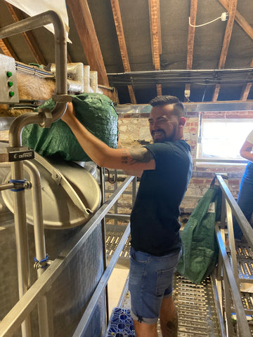 Matt adding hops to the beer brew